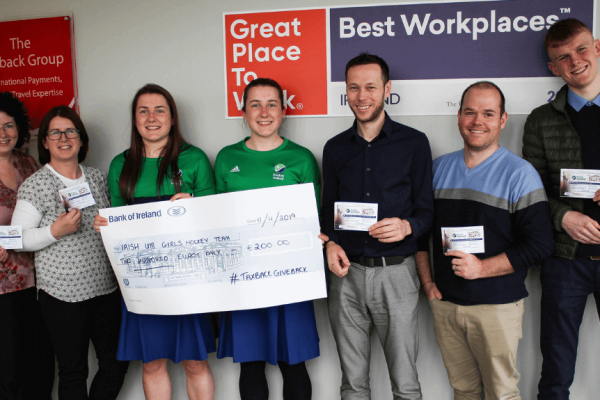 Hannah and Rachel Kelly accepting check from CluneTech Team