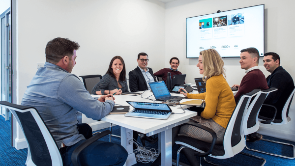 Benamic employees having a meeting in a boardroom