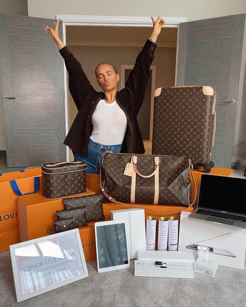 Molly-Mae standing behind Louie Vuitton bags for her competition giveaway