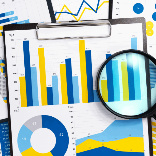 a clipboard with graph documents with a magnifying glass