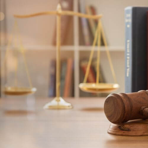 a gavel and balancing scale on a table