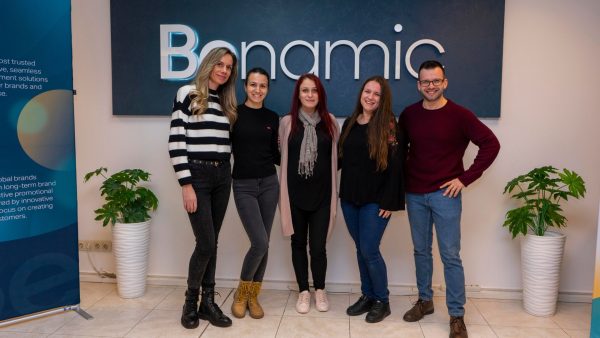 Benamic employees in front of Benamic sign at new Hybrid Office place