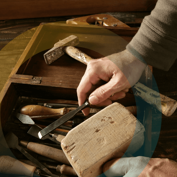 a man sharpening wooden tools from his toolbox