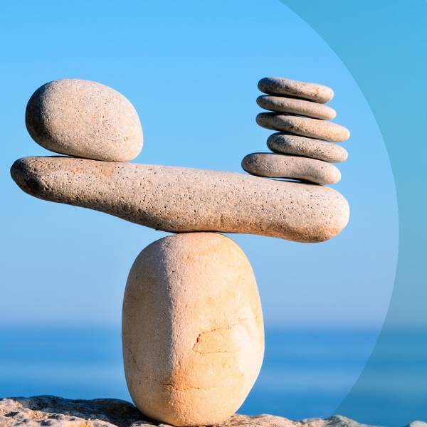 a balancing scales made out of stones