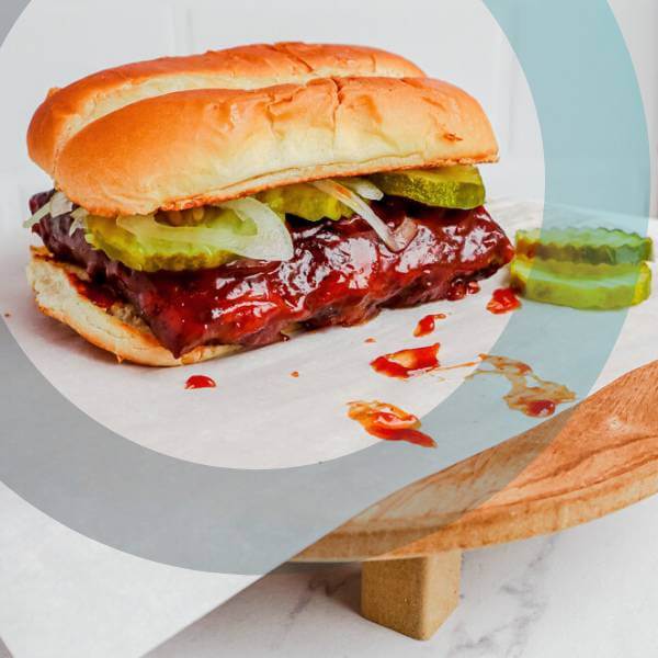 a takeaway burger on a wooden plate