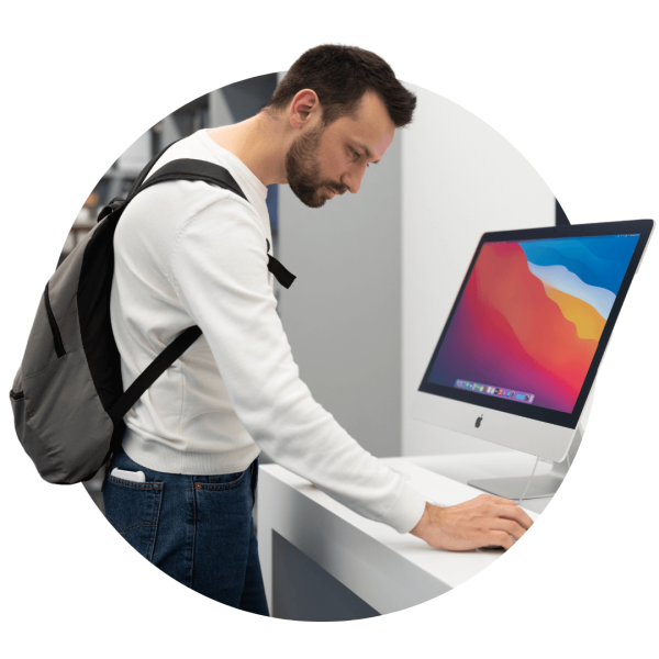 Man looking at Apple Mac in Apple Store