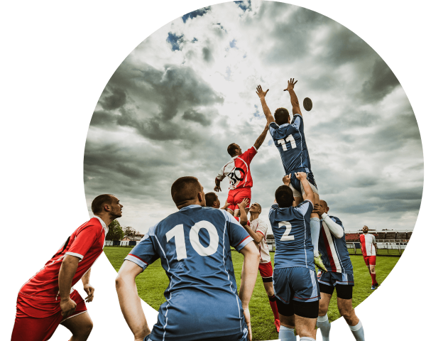 2 rugby players reaching for the rugby ball at a match