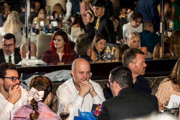 Benamic employees at a table at IMP Awards 2023