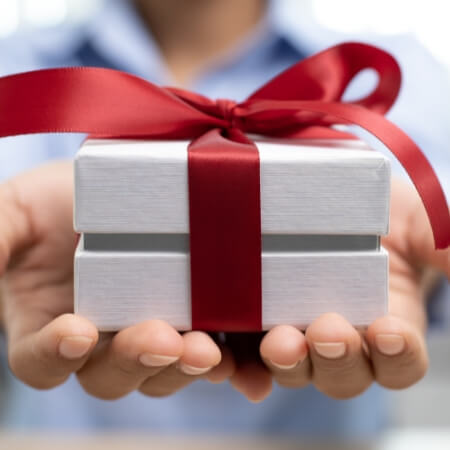 a man giving a giftbox to the camera