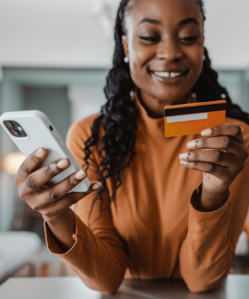 a woman putting in her card details into her phone