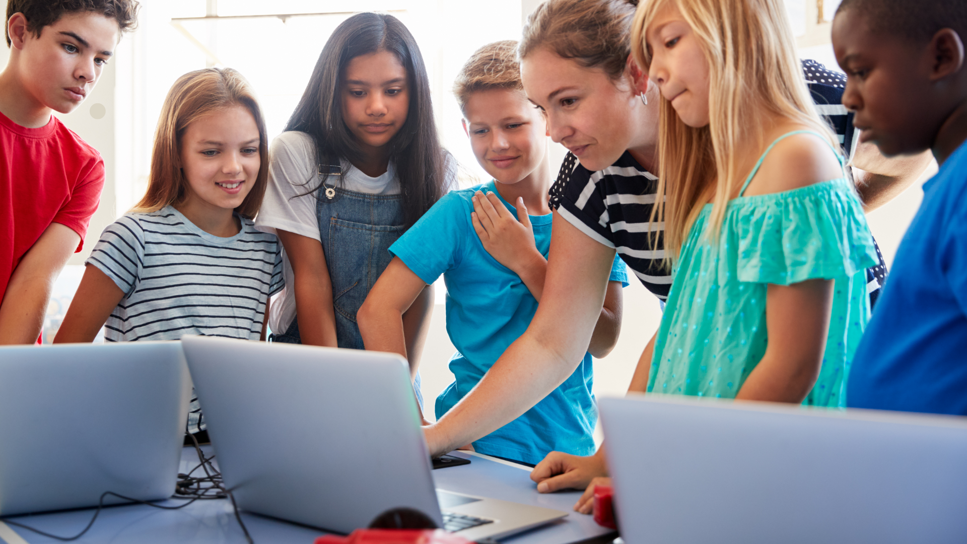 School Class of young Children and a teacher in front of computers
