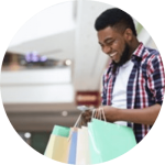 Man in shopping centre with shopping bags