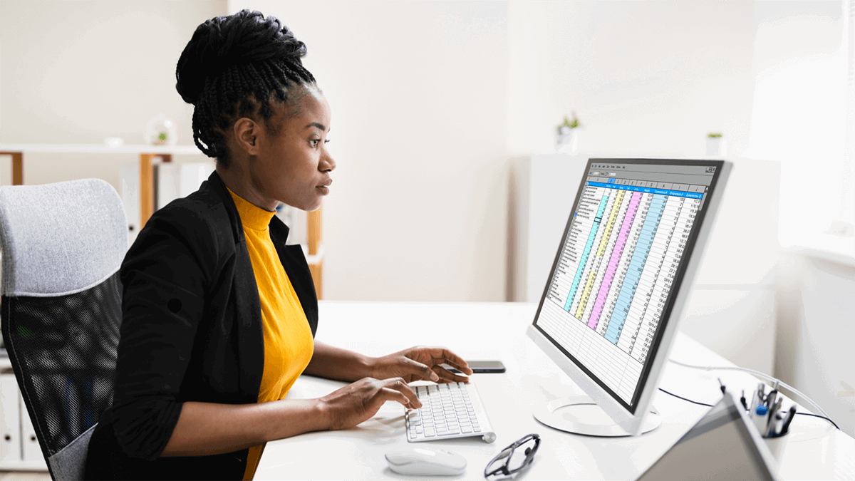 Woman checking spreadsheet on her desktop