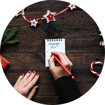 Woman writing a Christmas guft list