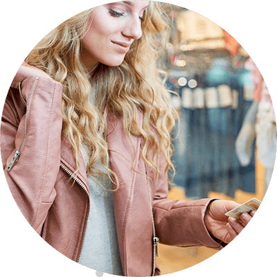 Woman inside shop checking her loyalty card